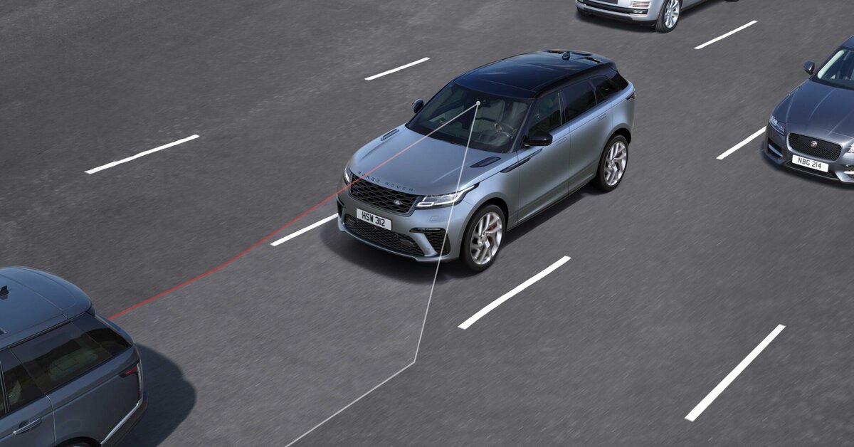 Driver checking ADAS sensors on a car